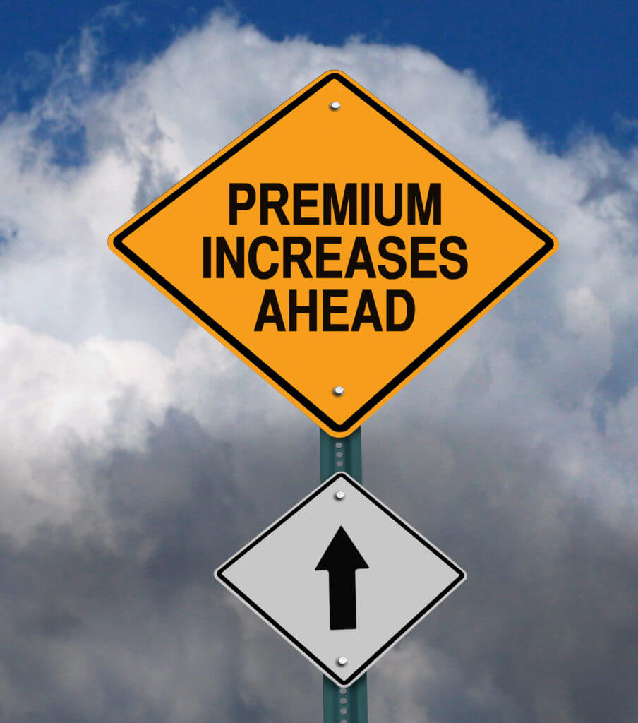 premium increases ahead road sign over dark blue sky with clouds