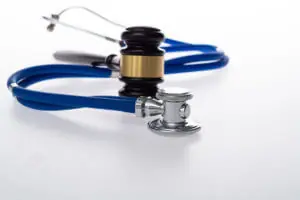 Gavel and stethoscope on white background